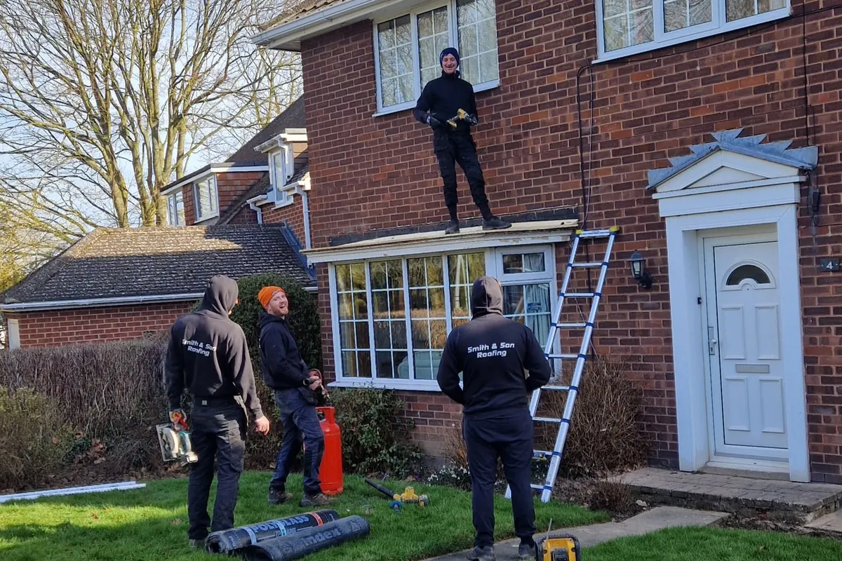 The Smith and Son roofing team on site in branded uniform